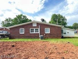 back of property featuring central AC
