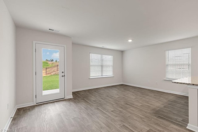 interior space with hardwood / wood-style floors and a healthy amount of sunlight