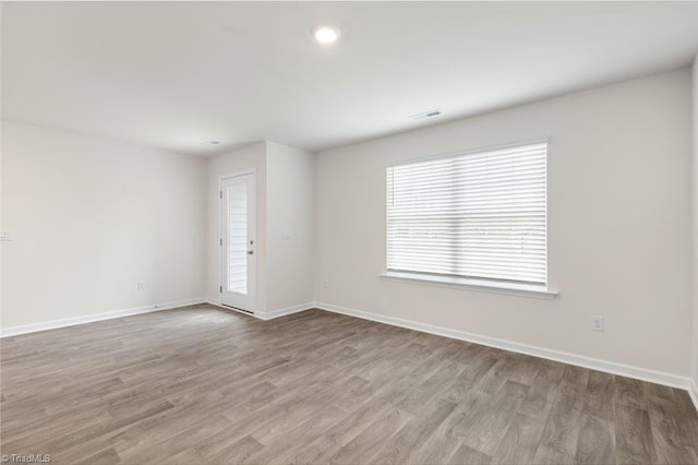 unfurnished room featuring light hardwood / wood-style floors