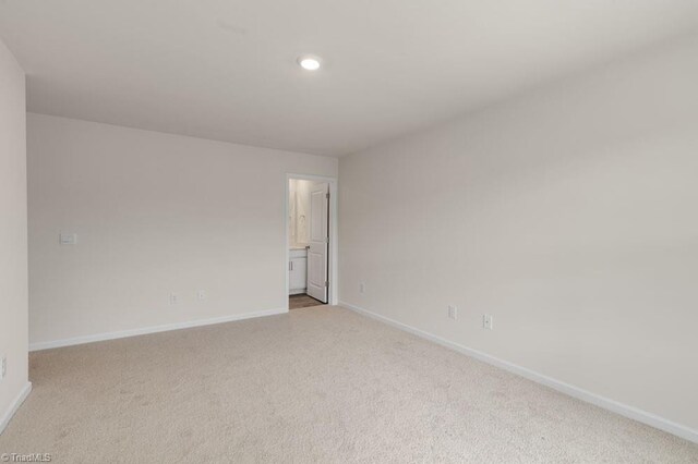 spare room with light colored carpet