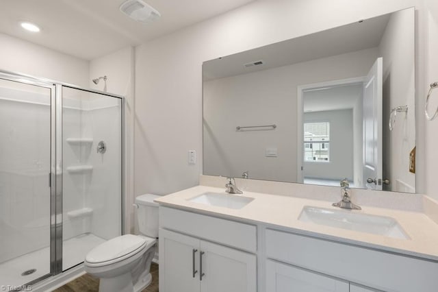 bathroom with vanity, hardwood / wood-style flooring, toilet, and walk in shower