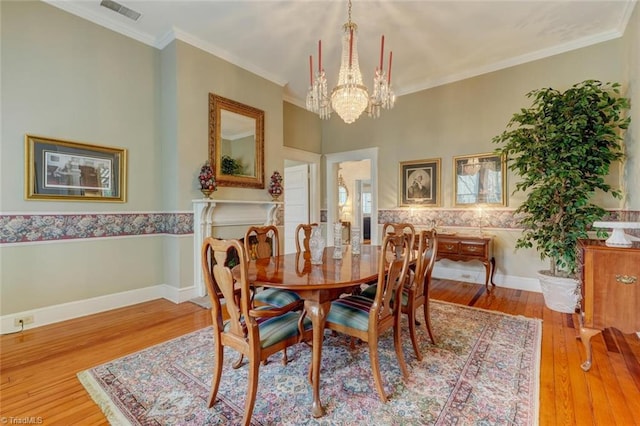 521 Patrick St, Eden, NC 27288 - dining space with a chandelier, hardwood / wood-style flooring, and ornamental molding