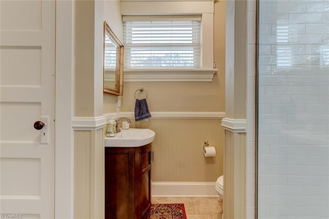 521 Patrick St, Eden, NC 27288 - bathroom featuring vanity, a wainscoted wall, toilet, a shower with shower door, and tile patterned floors