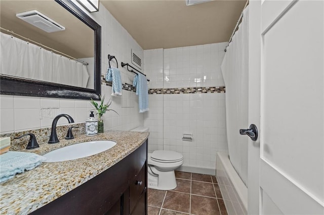 full bathroom with tile walls, backsplash, tile patterned floors, vanity, and toilet