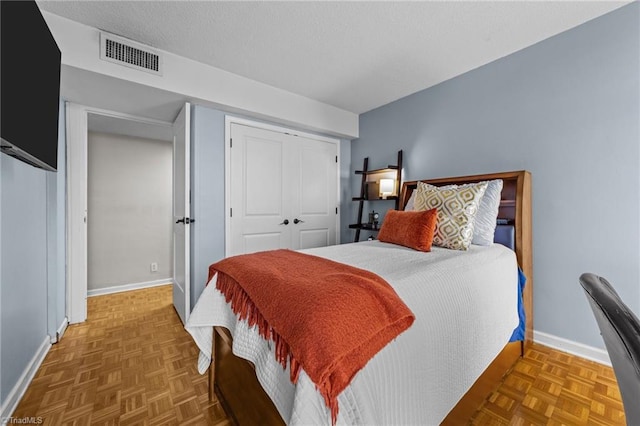 bedroom with a closet and parquet floors