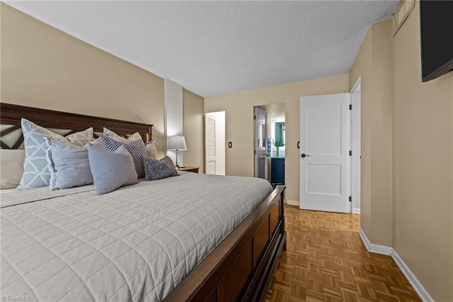 bedroom with a textured ceiling and parquet flooring