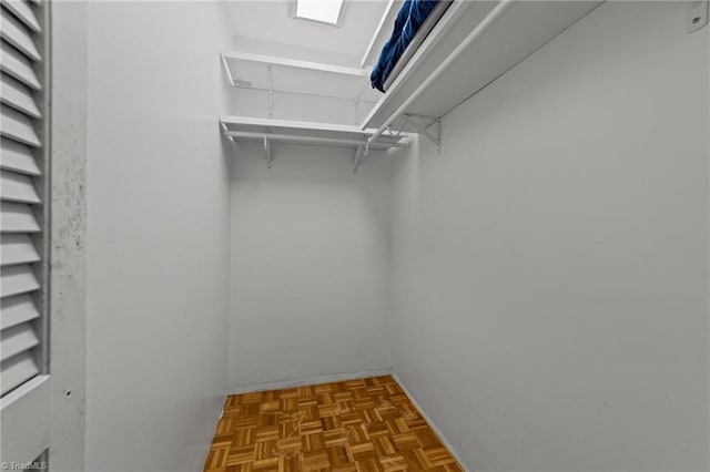 spacious closet with parquet floors