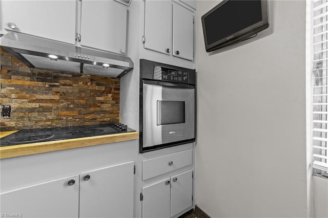 kitchen with oven, black cooktop, and tasteful backsplash