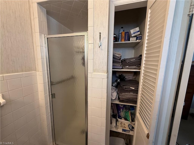 bathroom with tile walls and an enclosed shower