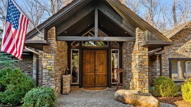 doorway to property featuring stone siding