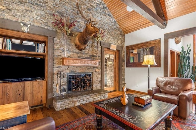 living room with high vaulted ceiling, beam ceiling, a stone fireplace, wood-type flooring, and wooden ceiling