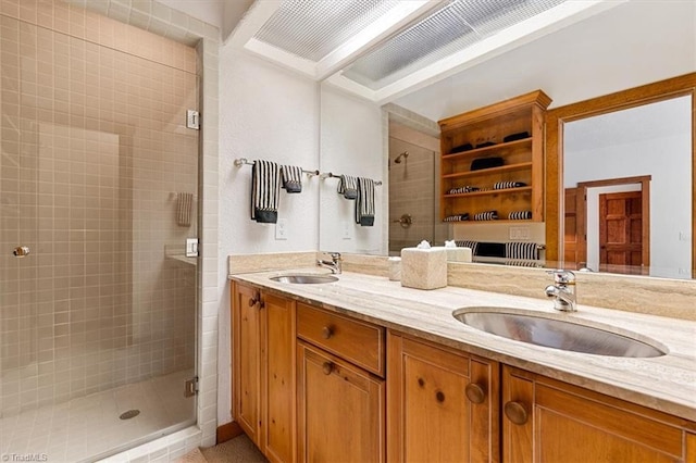 bathroom featuring double vanity, a shower stall, and a sink