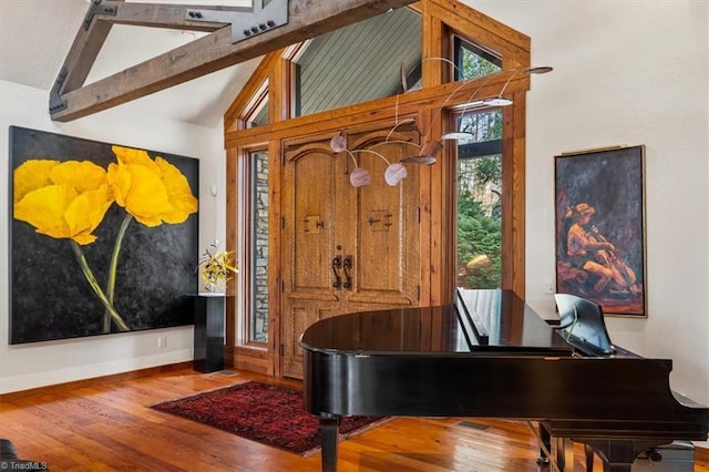 entrance foyer featuring beamed ceiling, baseboards, wood-type flooring, and high vaulted ceiling