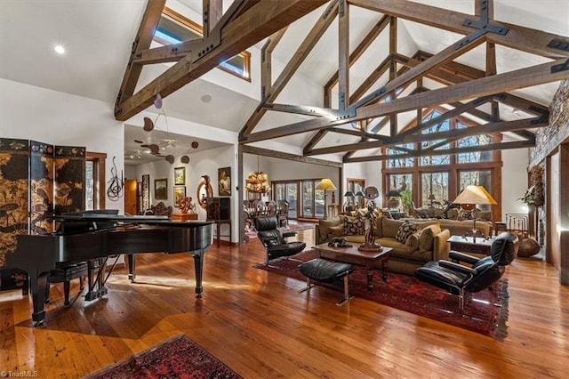 living area featuring lofted ceiling with beams and hardwood / wood-style floors