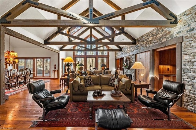 living area featuring lofted ceiling with beams and wood-type flooring