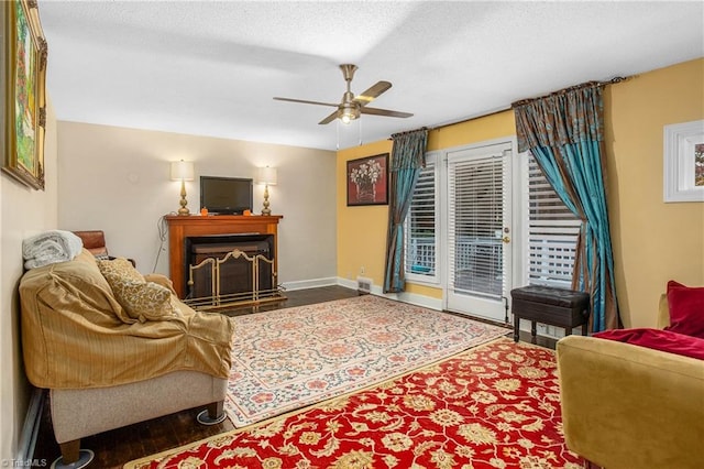 living room with ceiling fan and a textured ceiling