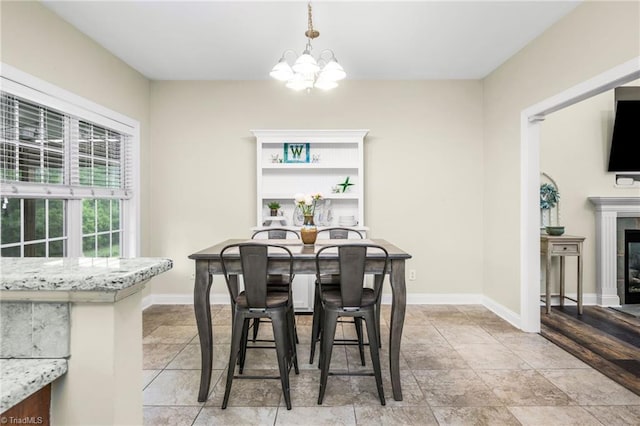 7255 Orchard Path Dr, Clemmons, NC 27012 - dining area with a chandelier, baseboards, and a glass covered fireplace