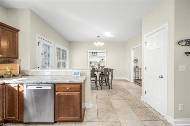 7255 Orchard Path Dr, Clemmons, NC 27012 - kitchen featuring stainless steel dishwasher, a chandelier, a peninsula, baseboards, and light stone counters