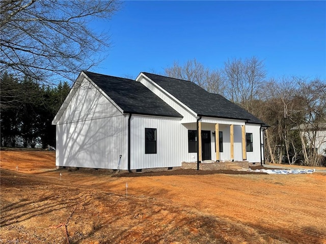 exterior space featuring crawl space and roof with shingles