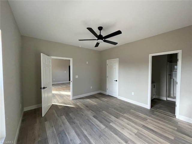 unfurnished bedroom with a ceiling fan, baseboards, and wood finished floors