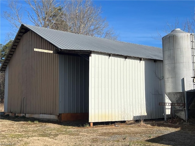 view of property exterior with an outbuilding