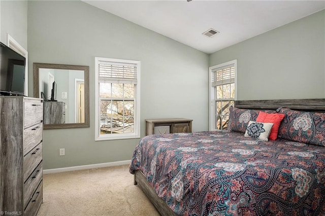 carpeted bedroom featuring visible vents, baseboards, and vaulted ceiling