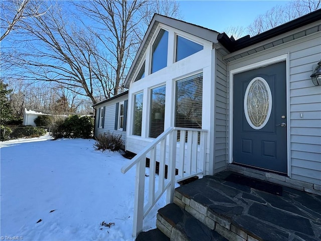 view of snow covered property entrance