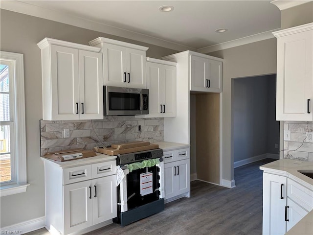 kitchen with white cabinetry, stainless steel appliances, dark hardwood / wood-style floors, and tasteful backsplash