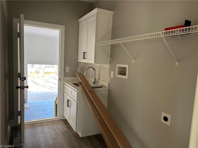 laundry room with sink, cabinets, dark hardwood / wood-style floors, electric dryer hookup, and washer hookup