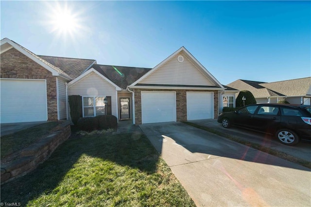 ranch-style house featuring a front lawn and a garage