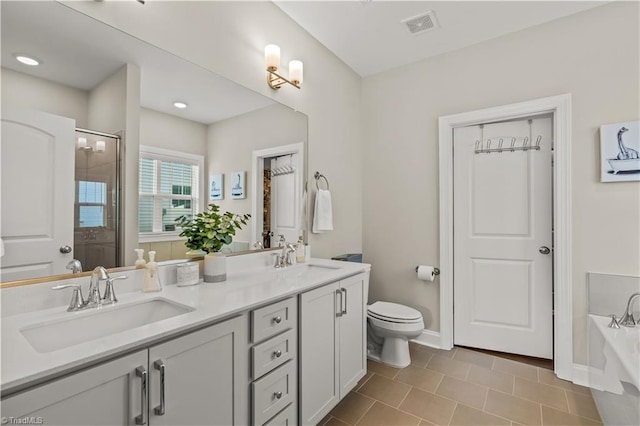 full bathroom with tile patterned flooring, vanity, separate shower and tub, and toilet