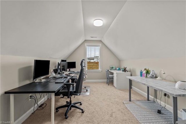 carpeted office space featuring vaulted ceiling