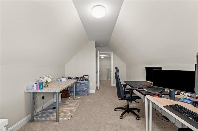 office space with light colored carpet and vaulted ceiling