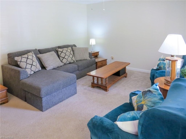 carpeted living area featuring baseboards