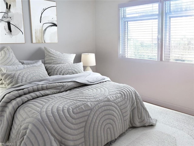 bedroom with multiple windows and carpet floors