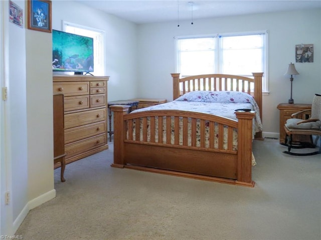 carpeted bedroom with baseboards