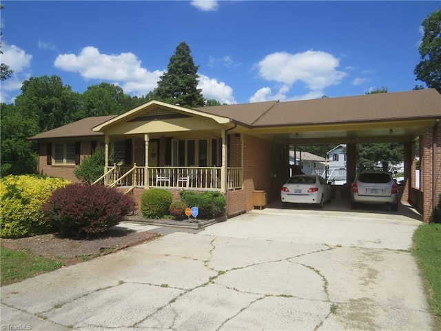 single story home with brick siding, driveway, covered porch, and a carport