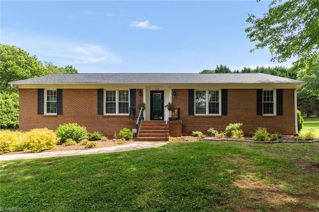 ranch-style house with a front yard and brick siding