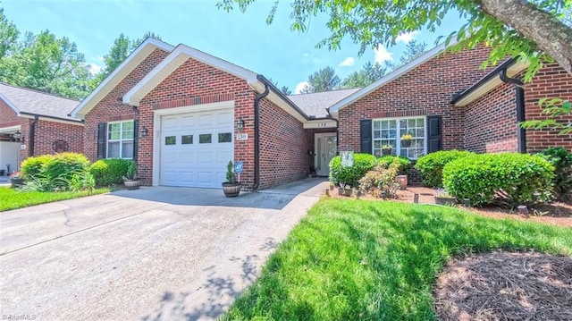 138 Wyndham Ct, High Point, NC 27265 - view of front of home with brick siding, an attached garage, and driveway