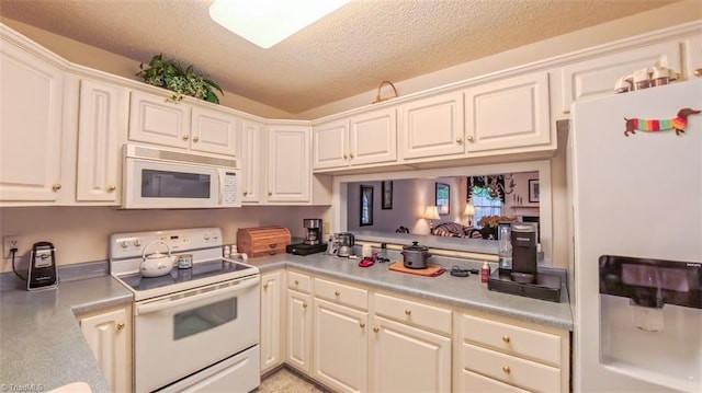 138 Wyndham Ct, High Point, NC 27265 - kitchen featuring white appliances, a textured ceiling, light countertops, and white cabinetry