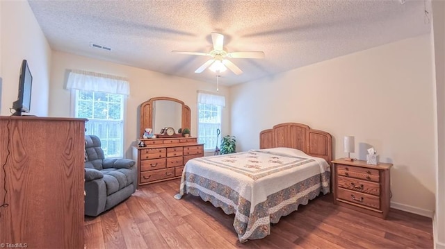 138 Wyndham Ct, High Point, NC 27265 - bedroom with wood finished floors, a textured ceiling, multiple windows, and ceiling fan