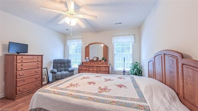 138 Wyndham Ct, High Point, NC 27265 - bedroom featuring multiple windows, wood finished floors, a textured ceiling, and ceiling fan