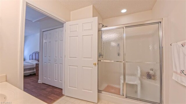 138 Wyndham Ct, High Point, NC 27265 - full bath featuring a stall shower, a textured ceiling, recessed lighting, wood finished floors, and vanity