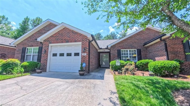 138 Wyndham Ct, High Point, NC 27265 - view of front of house featuring a garage, driveway, and brick siding