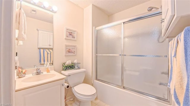 138 Wyndham Ct, High Point, NC 27265 - bathroom with vanity, bath / shower combo with glass door, toilet, tile patterned floors, and a textured ceiling