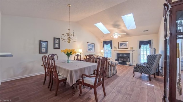138 Wyndham Ct, High Point, NC 27265 - dining room featuring wood finished floors, a skylight, a chandelier, baseboards, and high vaulted ceiling