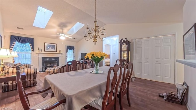 138 Wyndham Ct, High Point, NC 27265 - dining room with a skylight, dark wood-type flooring, lofted ceiling, a fireplace, and a ceiling fan