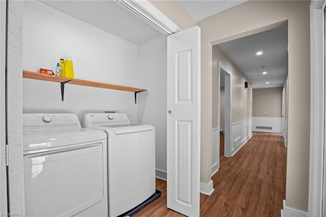 washroom with separate washer and dryer and hardwood / wood-style flooring