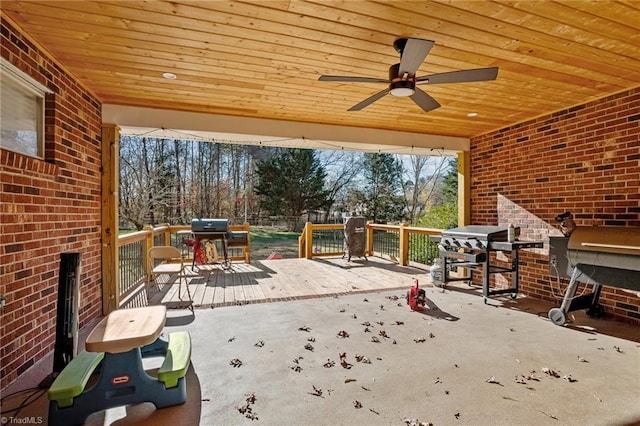 view of patio featuring a deck, ceiling fan, and a grill