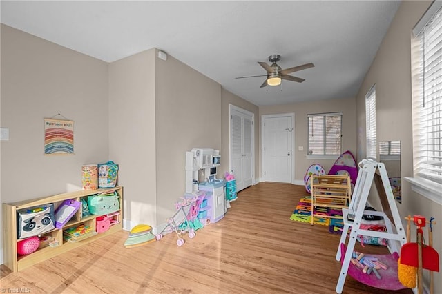 game room with wood-type flooring and ceiling fan